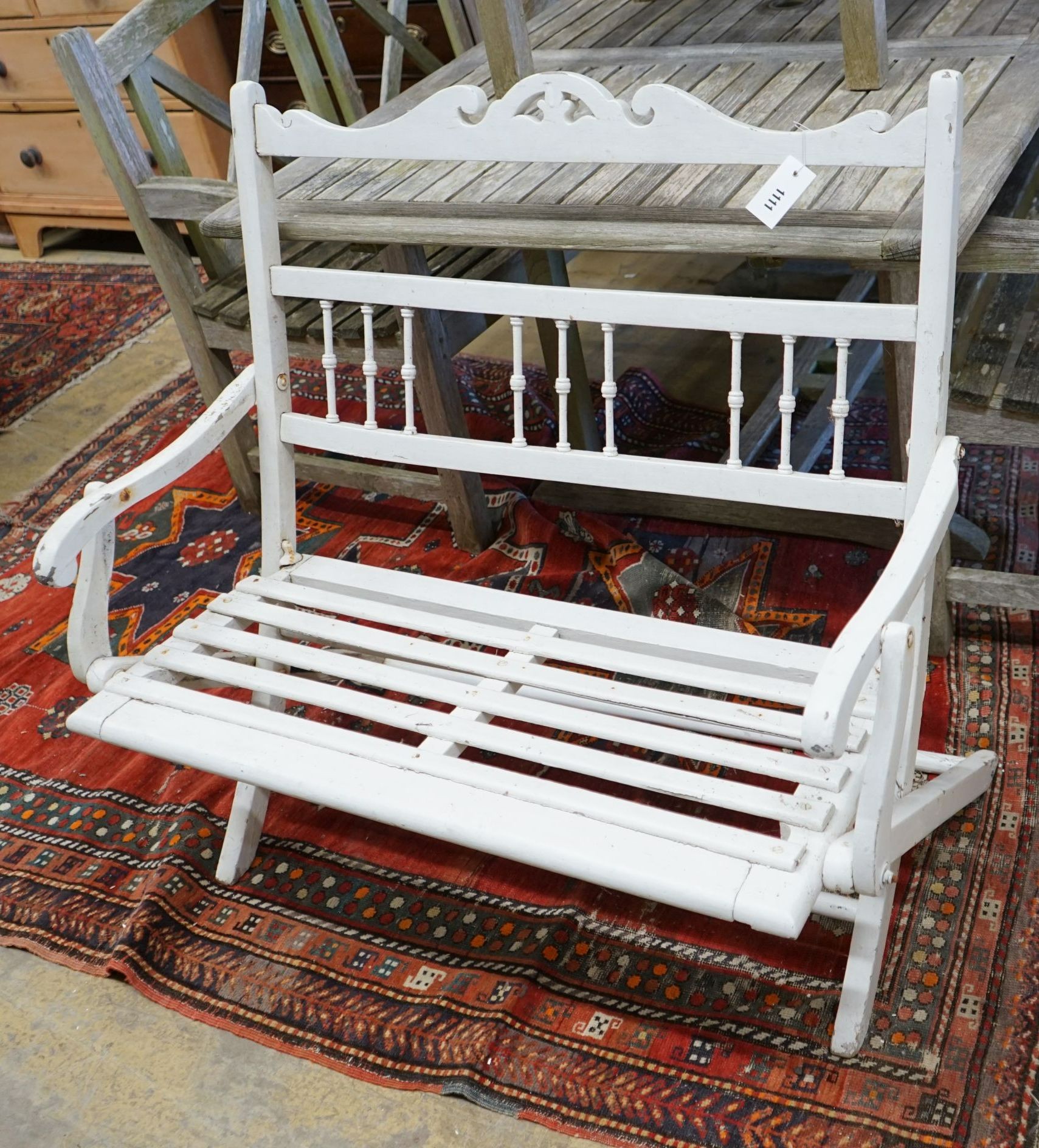 A painted slatted wood folding garden bench, length 97cm, depth 58cm, height 90cm